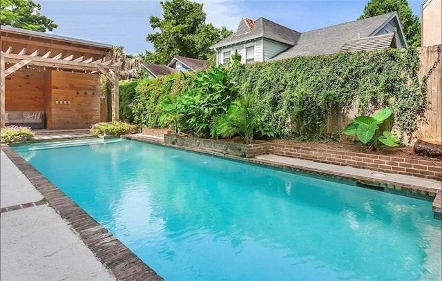 view of swimming pool with a pergola