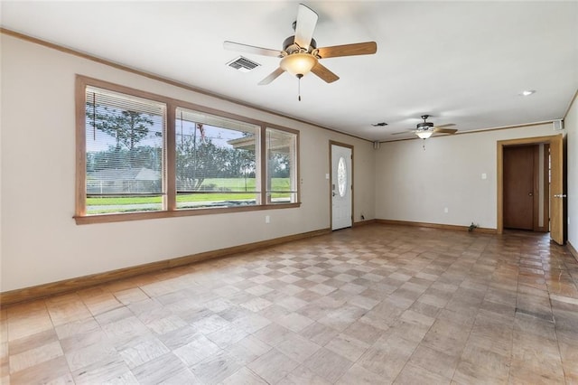 spare room with crown molding and ceiling fan