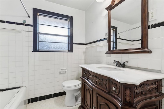 bathroom featuring vanity, toilet, tile walls, and tile patterned flooring