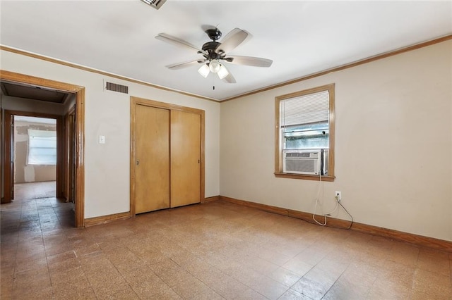 unfurnished bedroom with crown molding, cooling unit, a closet, and ceiling fan