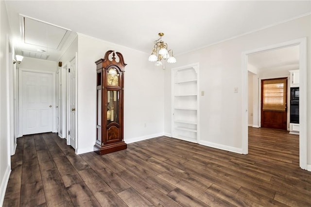 unfurnished dining area featuring crown molding, dark wood-type flooring, and built in shelves