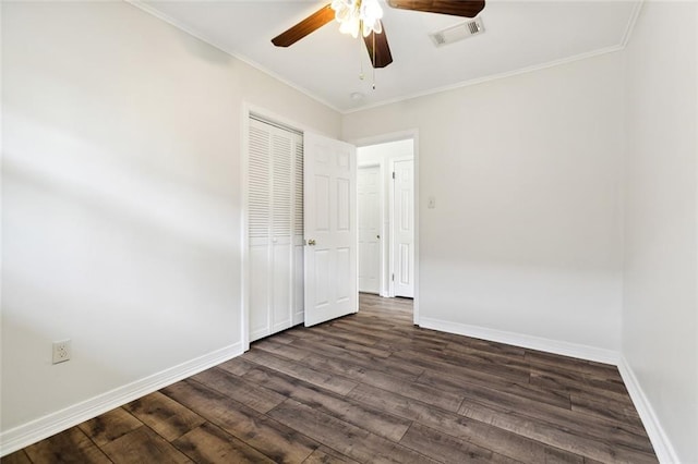 spare room featuring ornamental molding, ceiling fan, and dark hardwood / wood-style flooring