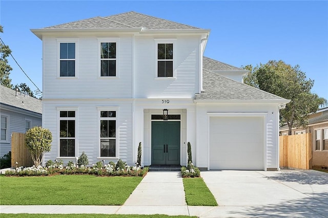 view of front of property with a front lawn and a garage