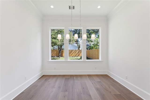 unfurnished dining area featuring ornamental molding and light wood-type flooring