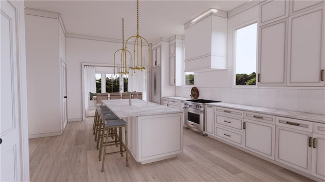 kitchen featuring appliances with stainless steel finishes, pendant lighting, light hardwood / wood-style flooring, a notable chandelier, and a kitchen island