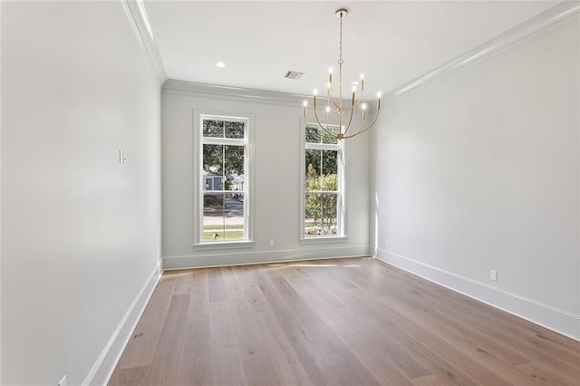 unfurnished dining area featuring a notable chandelier, light wood-type flooring, and crown molding