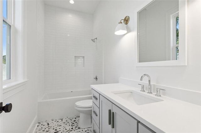 full bathroom featuring tile patterned floors, plenty of natural light, vanity, and toilet