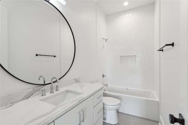 full bathroom featuring tile patterned flooring, vanity, toilet, and tiled shower / bath