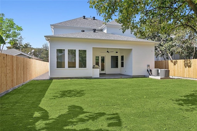 back of property with a lawn, ceiling fan, a patio area, and central AC