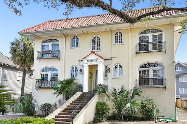 mediterranean / spanish house featuring a balcony