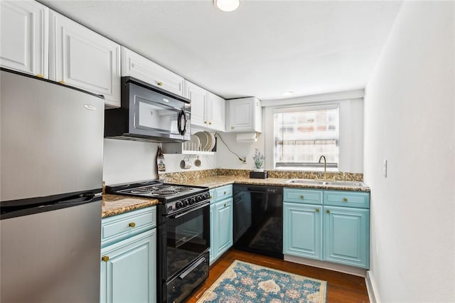 kitchen with stone countertops, sink, black appliances, white cabinetry, and dark hardwood / wood-style flooring