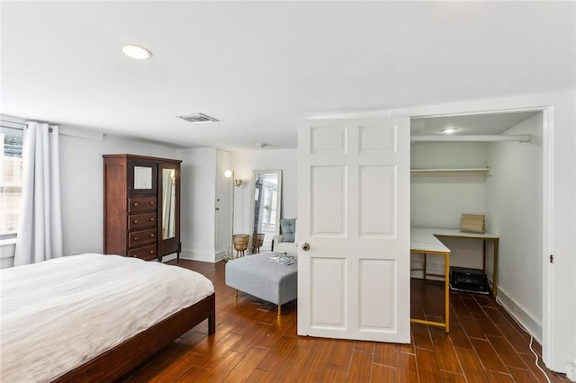 bedroom with a closet and dark hardwood / wood-style flooring