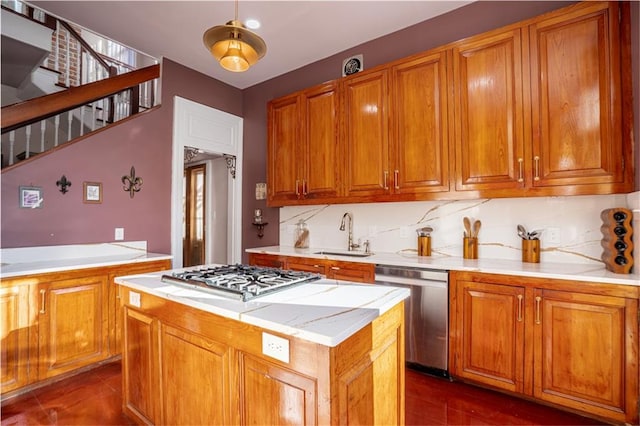 kitchen featuring appliances with stainless steel finishes, a center island, decorative backsplash, and sink