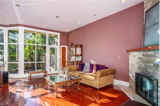 living room featuring a brick fireplace