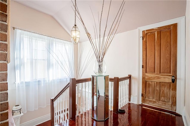 stairs featuring lofted ceiling and hardwood / wood-style flooring