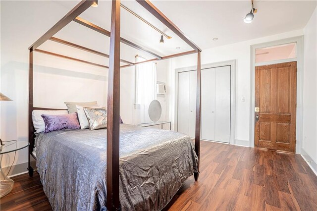 bedroom with dark hardwood / wood-style floors