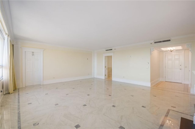 unfurnished room featuring ornamental molding and a chandelier