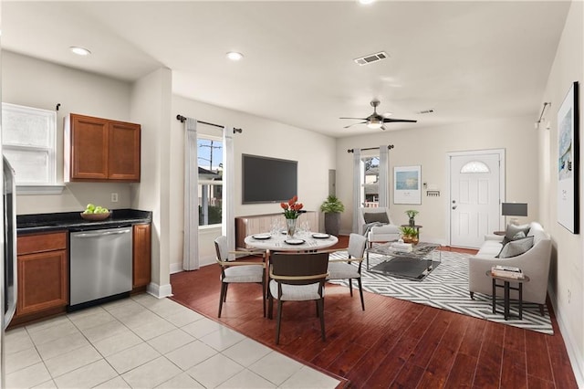 interior space with baseboards, light wood finished floors, visible vents, and plenty of natural light