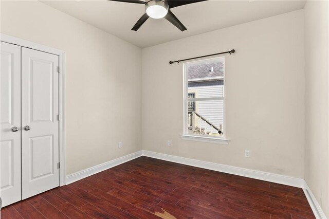 unfurnished bedroom with a closet, baseboards, ceiling fan, and hardwood / wood-style flooring