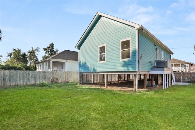 back of house with a yard and fence