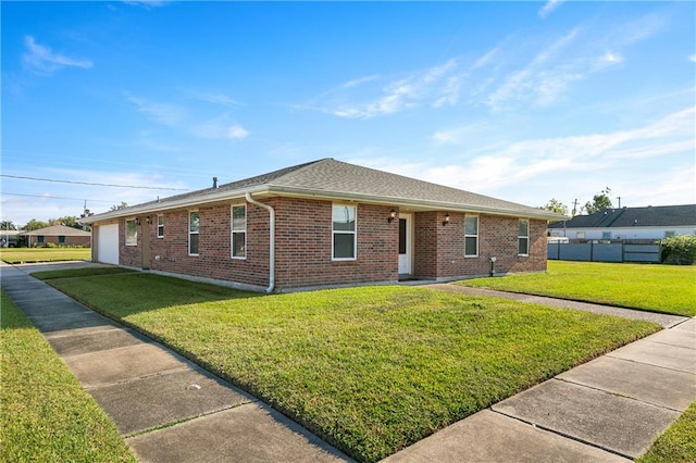 ranch-style home with a front lawn and a garage