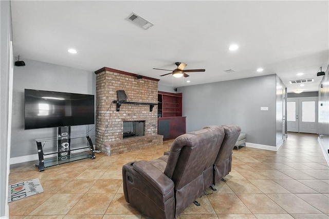 living room featuring french doors, ceiling fan, light tile patterned flooring, and a brick fireplace