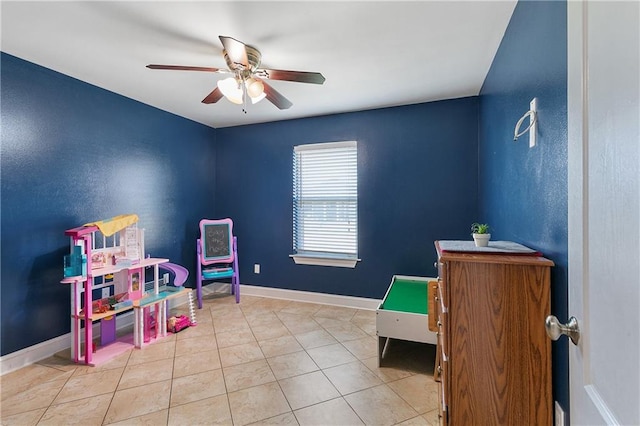 rec room with ceiling fan and light tile patterned floors