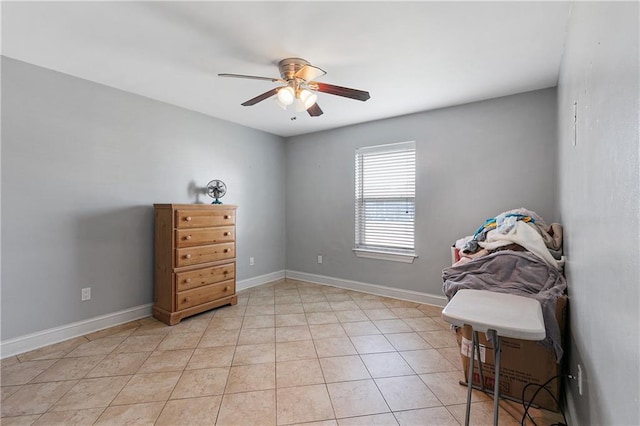 interior space with light tile patterned flooring and ceiling fan