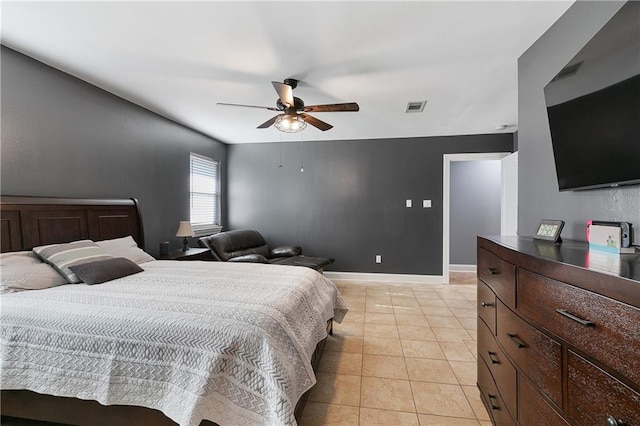 tiled bedroom featuring ceiling fan