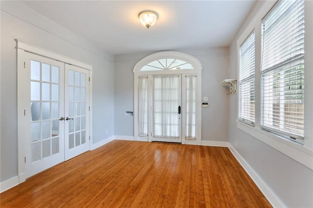 entryway with french doors and hardwood / wood-style floors