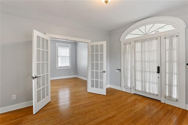 foyer entrance with french doors and hardwood / wood-style floors