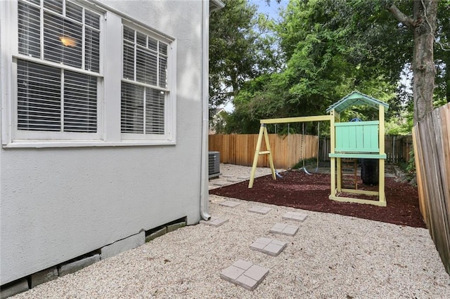 view of patio featuring central AC unit and a playground