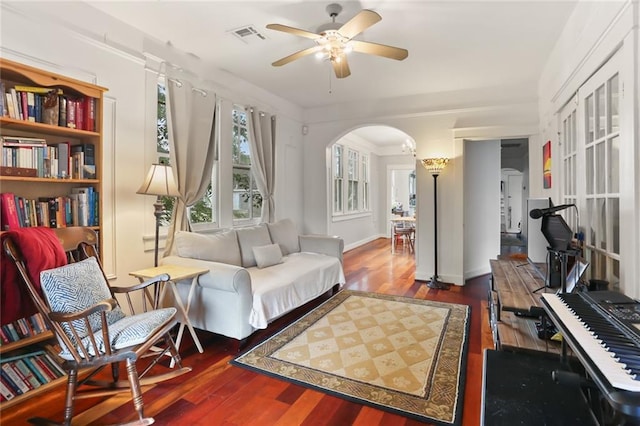 sitting room with dark wood-type flooring and ceiling fan