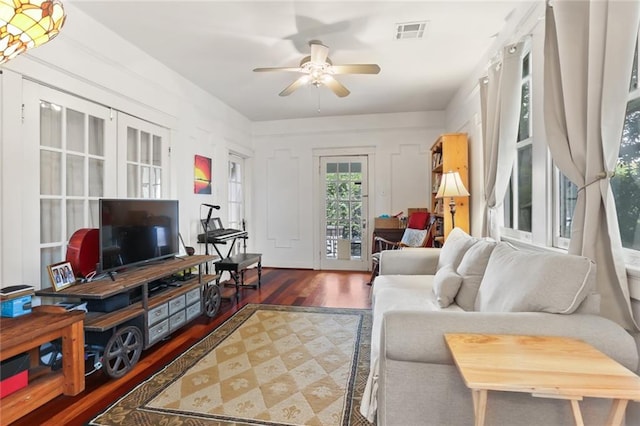 living room with ceiling fan and hardwood / wood-style flooring