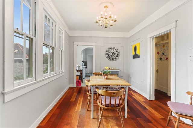 dining space with an inviting chandelier and dark hardwood / wood-style flooring