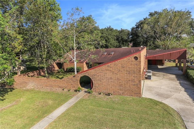 view of front of property with a front lawn and a carport