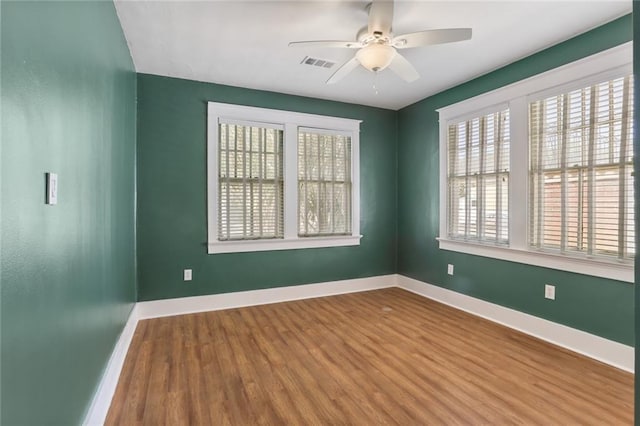 spare room with ceiling fan and hardwood / wood-style floors