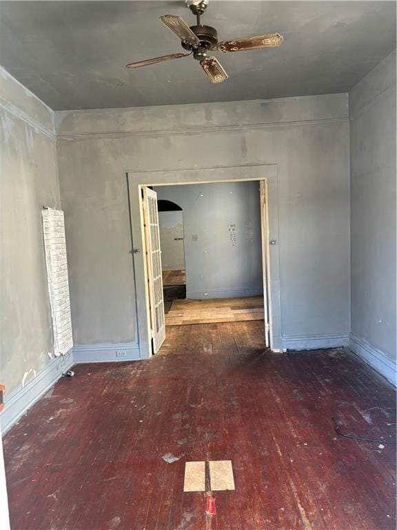 empty room with hardwood / wood-style flooring and ceiling fan