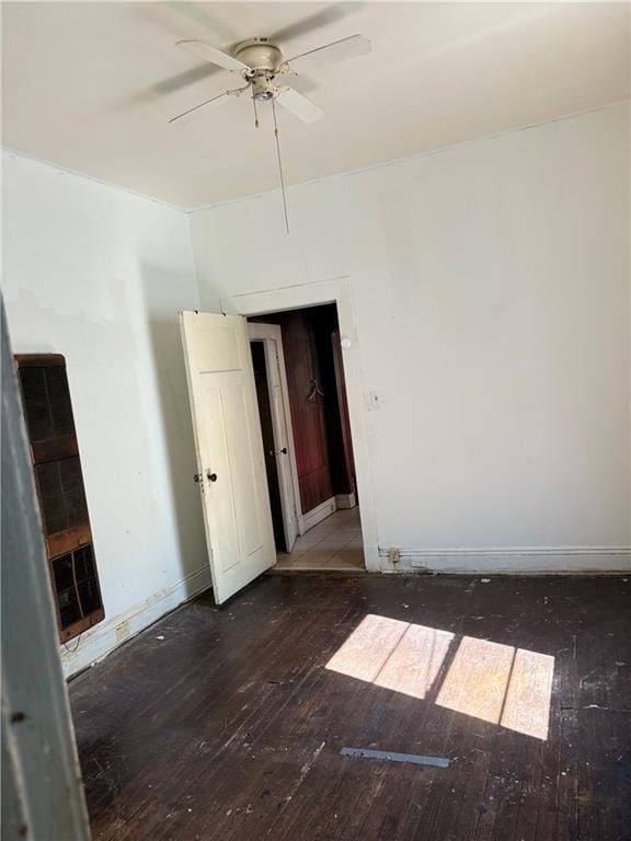 spare room with ceiling fan and dark hardwood / wood-style flooring