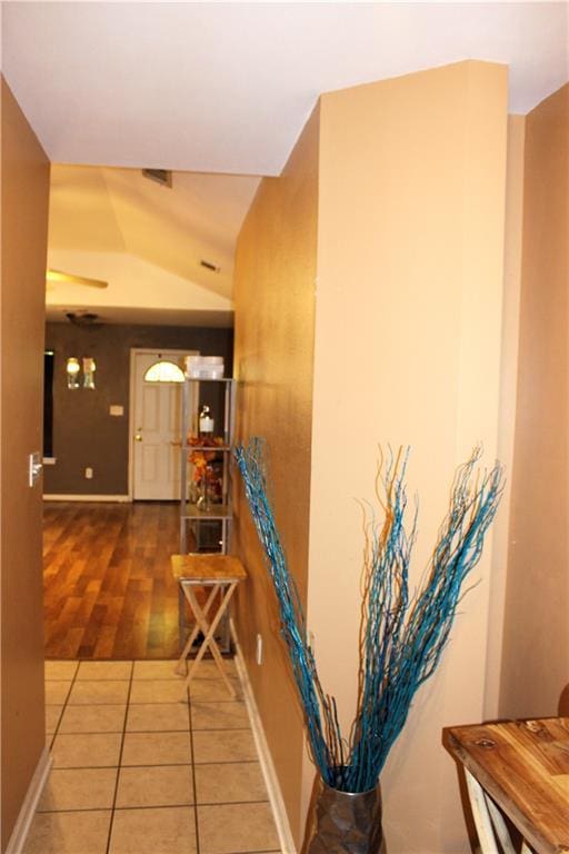 hall with tile patterned floors