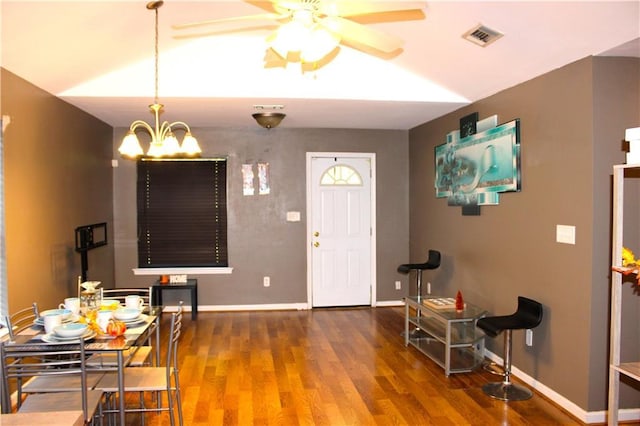 entryway with lofted ceiling, dark hardwood / wood-style floors, and ceiling fan with notable chandelier