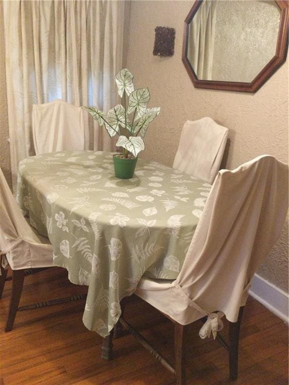 dining space with hardwood / wood-style floors