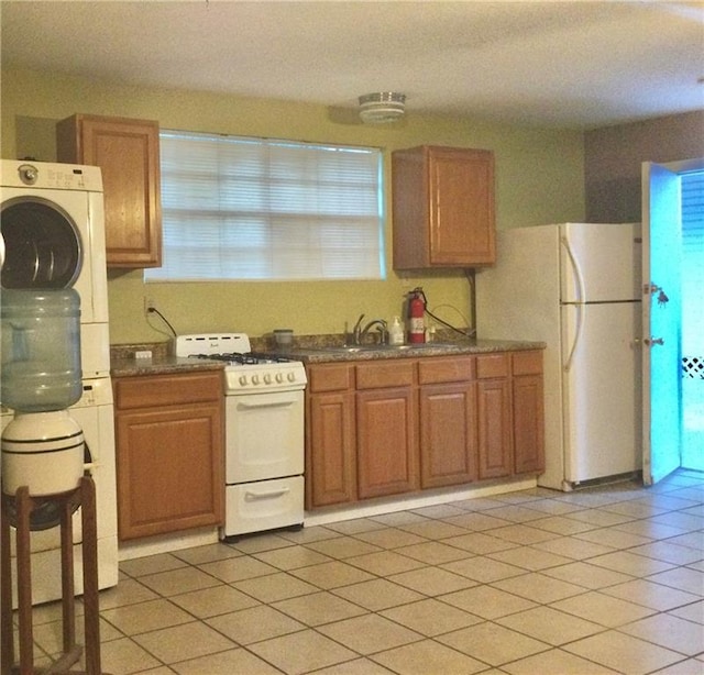 kitchen featuring sink, white appliances, and light tile patterned floors