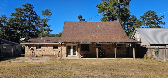 rear view of property with a yard and a patio