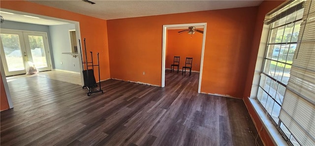 unfurnished room featuring french doors, ceiling fan, and dark hardwood / wood-style flooring