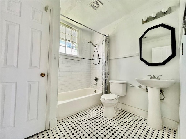 bathroom with toilet and shower / tub combo