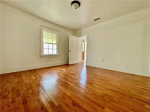 unfurnished room with hardwood / wood-style floors