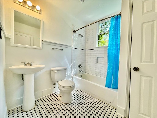 full bathroom featuring sink, tile patterned flooring, toilet, and shower / bathtub combination with curtain