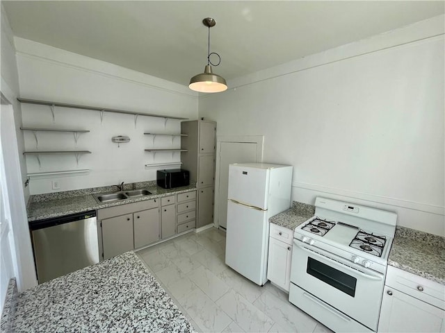 kitchen featuring white appliances, white cabinetry, sink, and decorative light fixtures