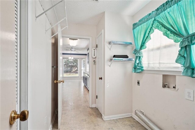 laundry area with hookup for a washing machine, a textured ceiling, ceiling fan, and electric dryer hookup